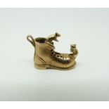 A 9ct gold charm in the form of a boot with two mice,