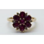 A white gold ring set with rubies and diamonds in a flower cluster (size K)