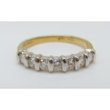 An 18ct gold ring set with seven diamonds in a white gold setting, 3.