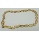 A yellow metal bracelet made up of foliate links (4.