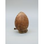 A stoneware or pottery ovoid vessel probably of some antiquity, with collared rim and hanging loop,