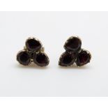 A pair of early Victorian earrings set with three foiled garnets to each