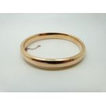 A rose gold bangle, 14.