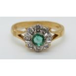 A 9ct gold ring set with a round emerald surrounded by diamonds in a flower cluster (size L)