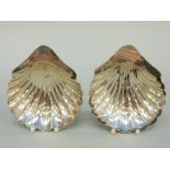 A pair of Edward VII hallmarked silver shell shaped three footed bonbon dishes,
