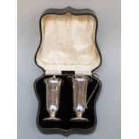 A George V hallmarked silver strawberry set comprising sugar sifter and cream jug, Sheffield 1926,