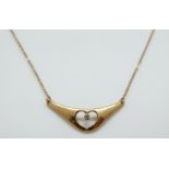 A 9ct gold necklace set with a diamond in a heart shape, 1.