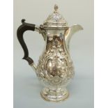 An Edward VII hallmarked silver hot water jug with repoussé decoration, Chester 1904, height 23.