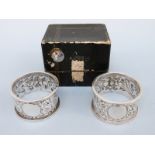 A cased pair of Victorian hallmarked silver napkin rings, Birmingham 1892 maker Nathan & Hayes,