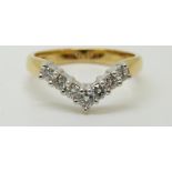 An 18ct gold ring set with diamonds in a V shape setting, 3.