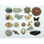 A collection of brooches including filigree, enamel butterfly,