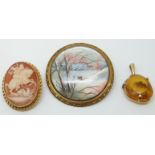 A 9ct gold brooch set with a cameo, a painted brooch and an amber set pendant.