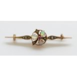 A yellow metal brooch marked 333 set with three opals, a ruby and seed pearls,