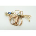 A 14ct gold brooch in a stylized bouquet design set with an old cut diamond of approximately 0.