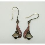 A pair of silver Arts & Crafts earrings each set with a moonstone