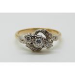 An 18ct gold ring set with three diamonds in a platinum setting (size P)