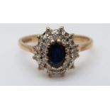 A 9ct gold ring set with a sapphire surrounded by diamonds (size N)