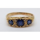 An 18ct gold ring set with three sapphires and four diamonds (size M)