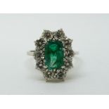 An 18ct gold ring set with an emerald cut apple green emerald of approximately 1.
