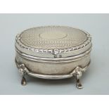 A George V hallmarked silver four footed casket raised on four shaped feet, B'ham 1911,