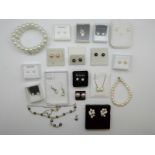 A collection of pearls, including a silver necklace set with pearls, pearl bracelet,