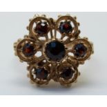 A 9ct gold ring set with garnets in a cluster (size M)