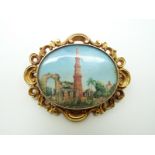 A Victorian yellow metal brooch set with a painted Indian miniature depicting Qutub Minar set with