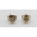 A pair of 18ct gold earrings each set with a diamond