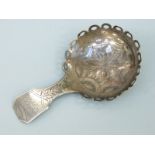 A Georgian hallmarked silver caddy spoon with unusual looped rim,