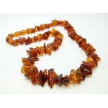 An amber necklace of translucent irregular shaped beads 50g, 53cm long.