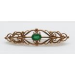 A 9ct gold brooch set with an oval emerald measuring approximately 0.75ct, 4.
