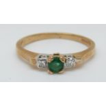 A 9ct gold ring set with a round cut emerald and two diamonds (size N)
