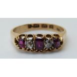 An 18ct gold Edwardian ring set with a diamond and rubies (size J)