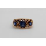 An 18ct gold ring set with three oval cut sapphires and four diamonds (size K/L)