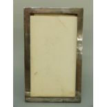 A large George VI hallmarked silver photograph frame to suit 12x7" photo, Birmingham 1945,