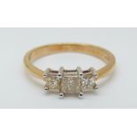 An 18ct gold ring set with three princess cut diamonds, total diamond weight approximately 0.