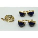 A pair of yellow metal cufflinks set with lapis lazuli cabochons