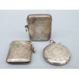 Three hallmarked silver vestas with vacant cartouches including a circular example