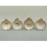 Four Victorian and later hallmarked silver shell dishes, raised on three ball feet, Sheffield 1893,