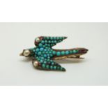 A Victorian gilt brooch in the form of a swallow set with turquoise cabochons,