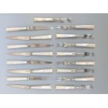 A set of eight hallmarked silver cake knives and forks with mother of pearl handles (eight knives