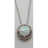 A silver necklace set with an opal cabochon and diamonds