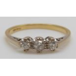 An 18ct gold ring set with three round cut diamonds (size R)