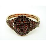 A Victorian bangle set with garnets