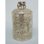 An Indian or similar white metal pot with embossed decoration,