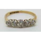 An 18ct gold ring set with five old cut diamonds, the largest approximately 0.25ct, 2.