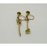 A pair of yellow metal earrings in a stylised flower design