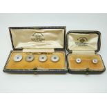 A set of four 9ct gold and platinum buttons set with mother of pearl and sapphires to the centre in
