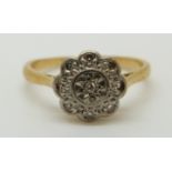 An 18ct gold ring set with diamonds in a platinum setting, 2.