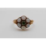 A Victorian 15ct gold ring set with a square cut peridot surrounded by opals (size M/N)
